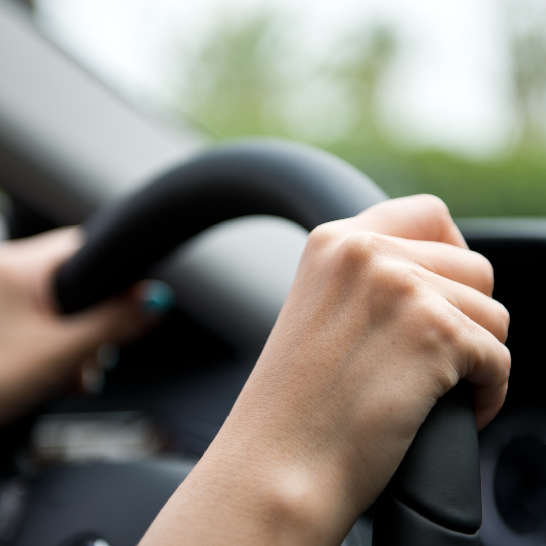 close up of hands gripping the steering wheel